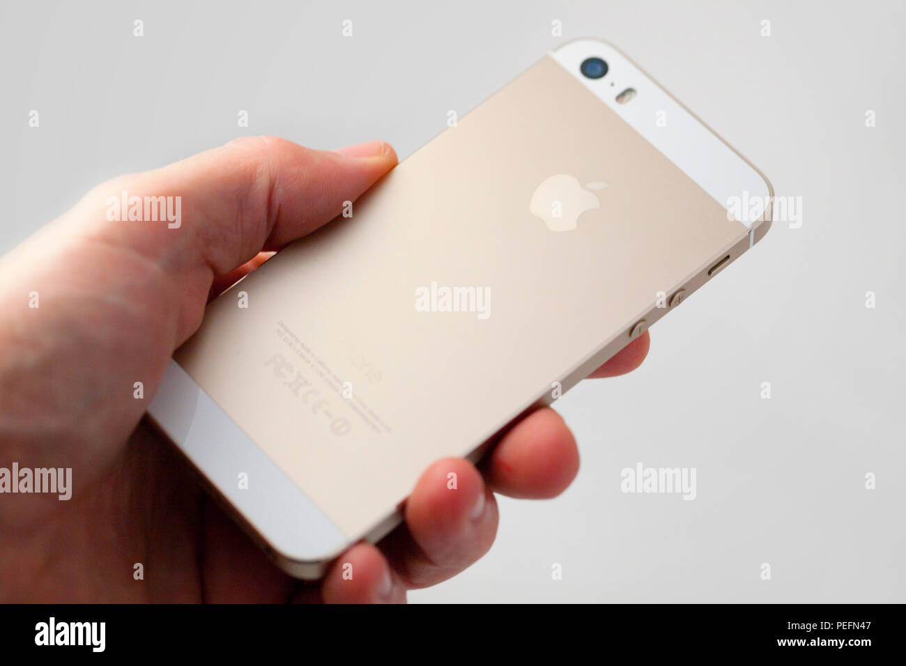 Hand holding brand new Apple iPhone SE Stock Photo