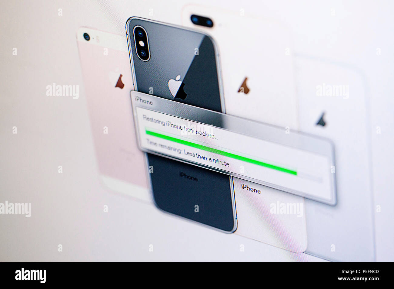 Screen capture of iTunes restoring an iPhone Stock Photo
