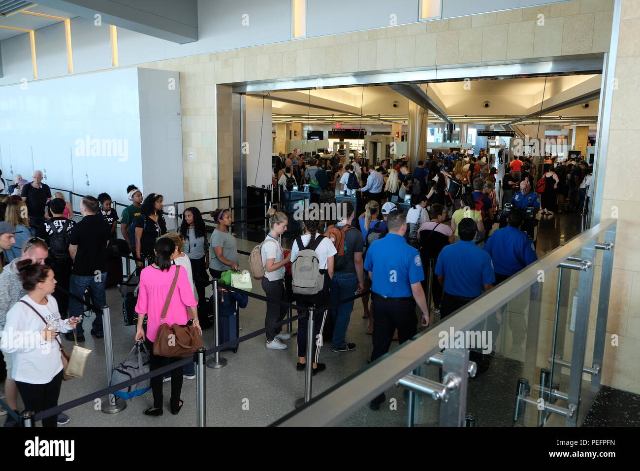 Passengers standing in line (queue) at Terminal 2 waiting to pass