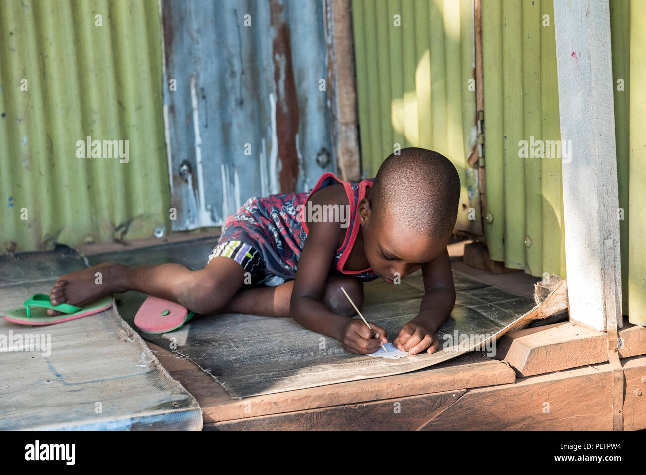 Uganda - Kampala kid studying Stock Photo