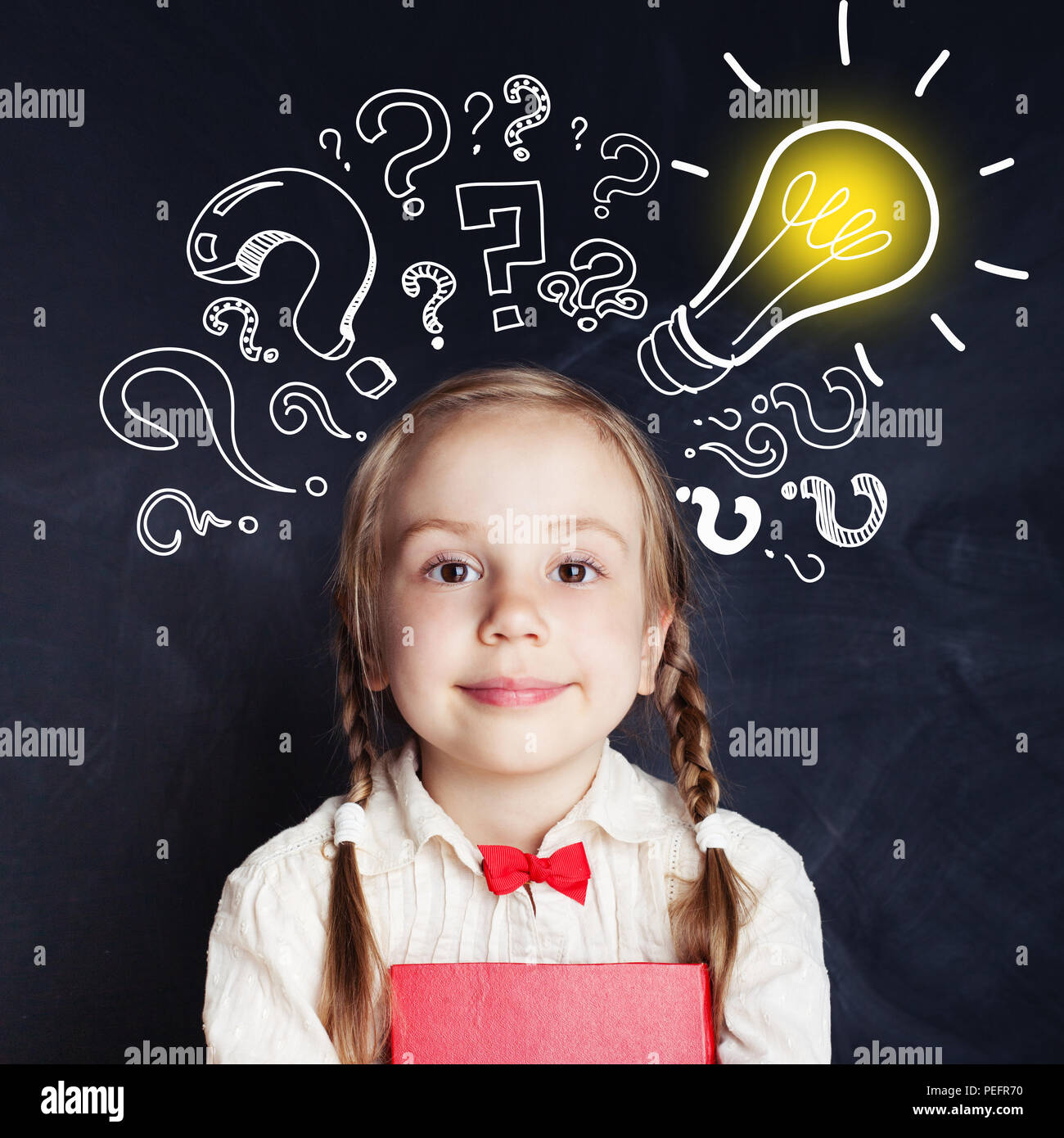 Curious kid of school age with lightbulb and chalk question marks. Brainstorm and idea concept Stock Photo