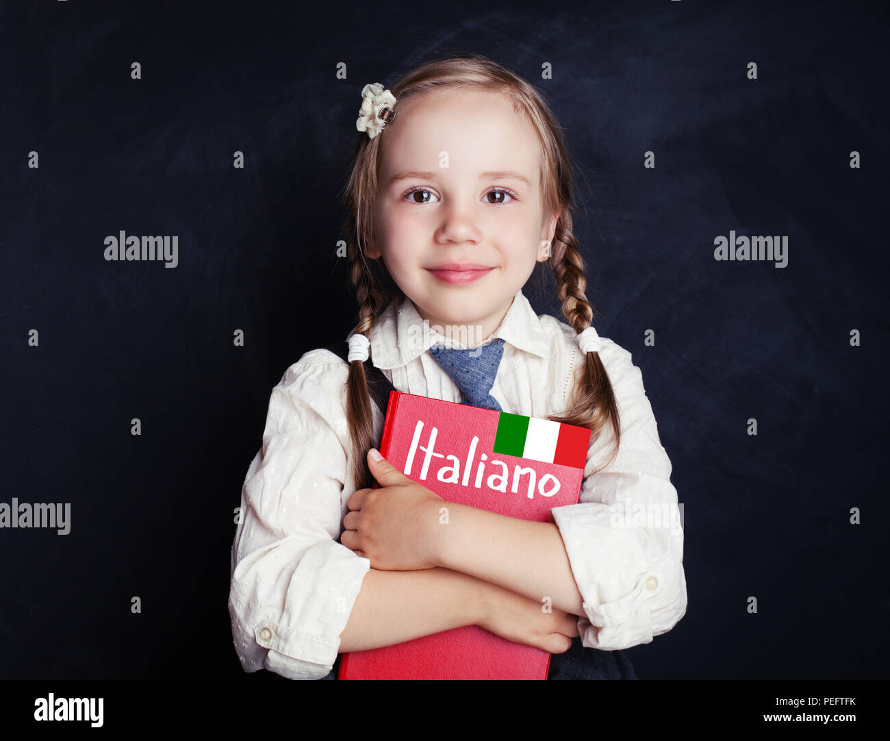 Cute little girl learning italian. Learning Italian language concept Stock Photo