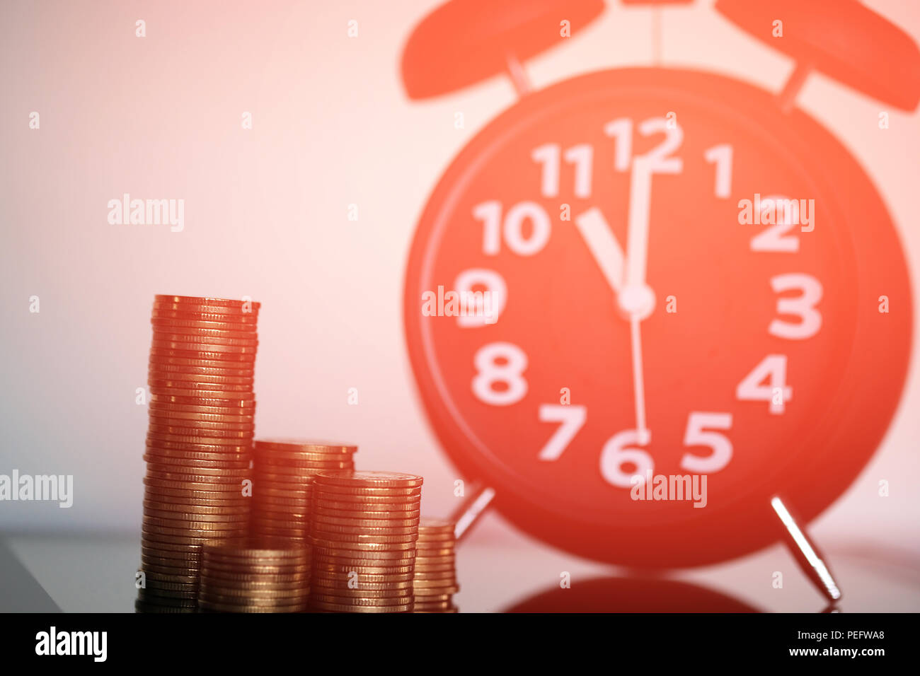 Step of coins stacks and alarm clock with tablet computer and financial ...