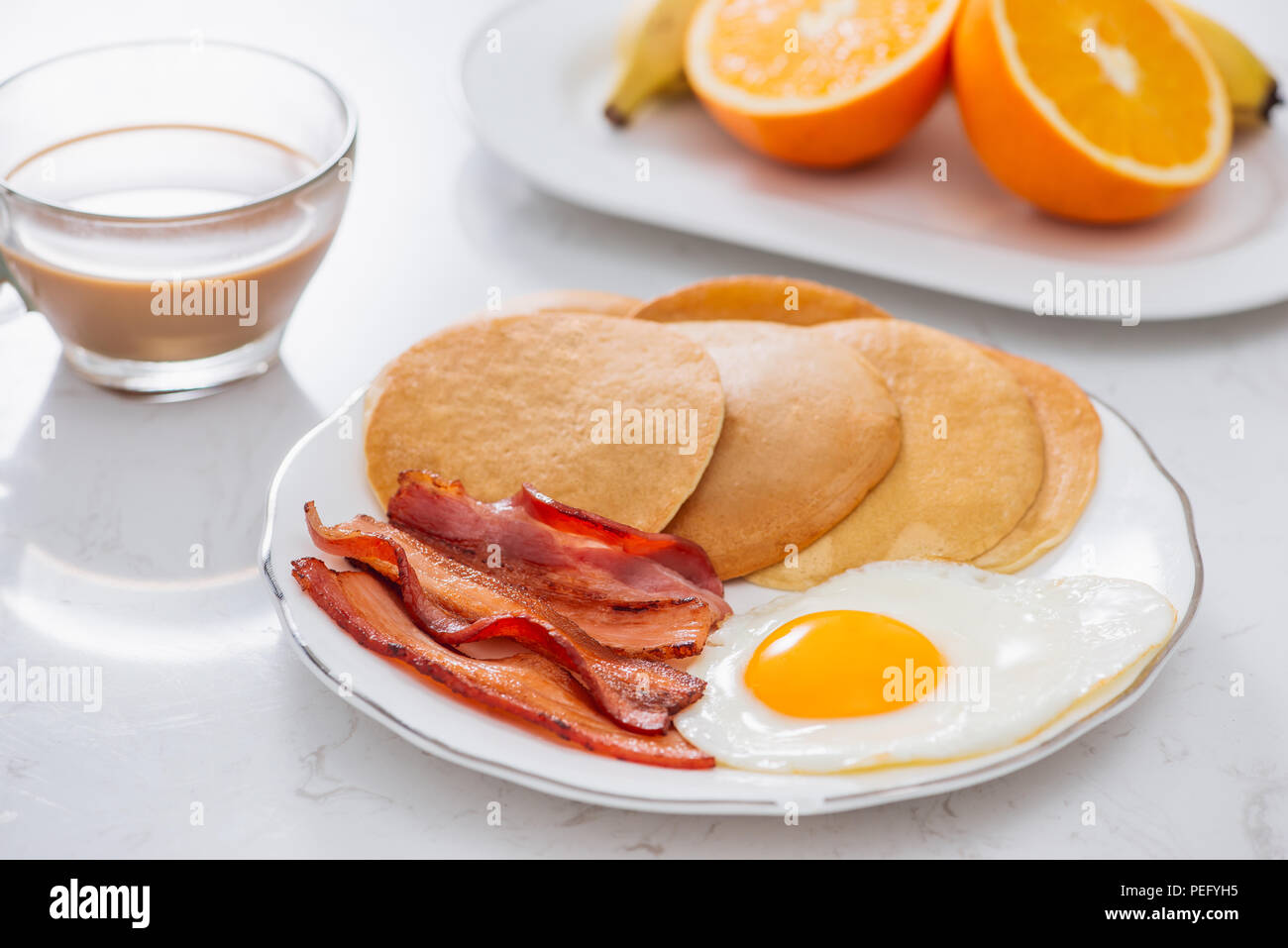 Healthy Full American Breakfast with Eggs Bacon and Pancakes Stock Photo