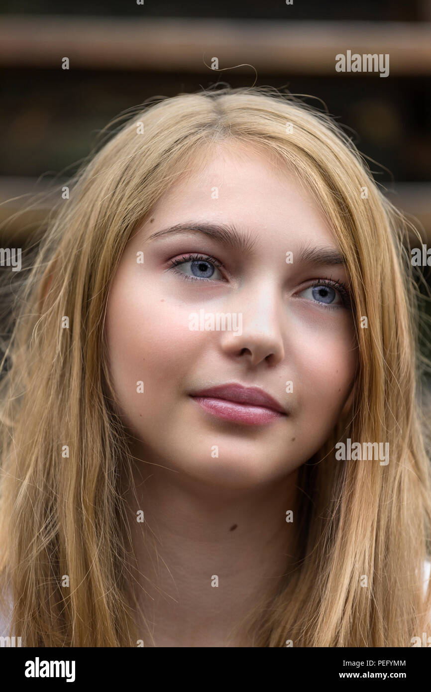 Close up candid portrait of beautiful and pretty 15 year old teenage female caucasian girl Stock Photo