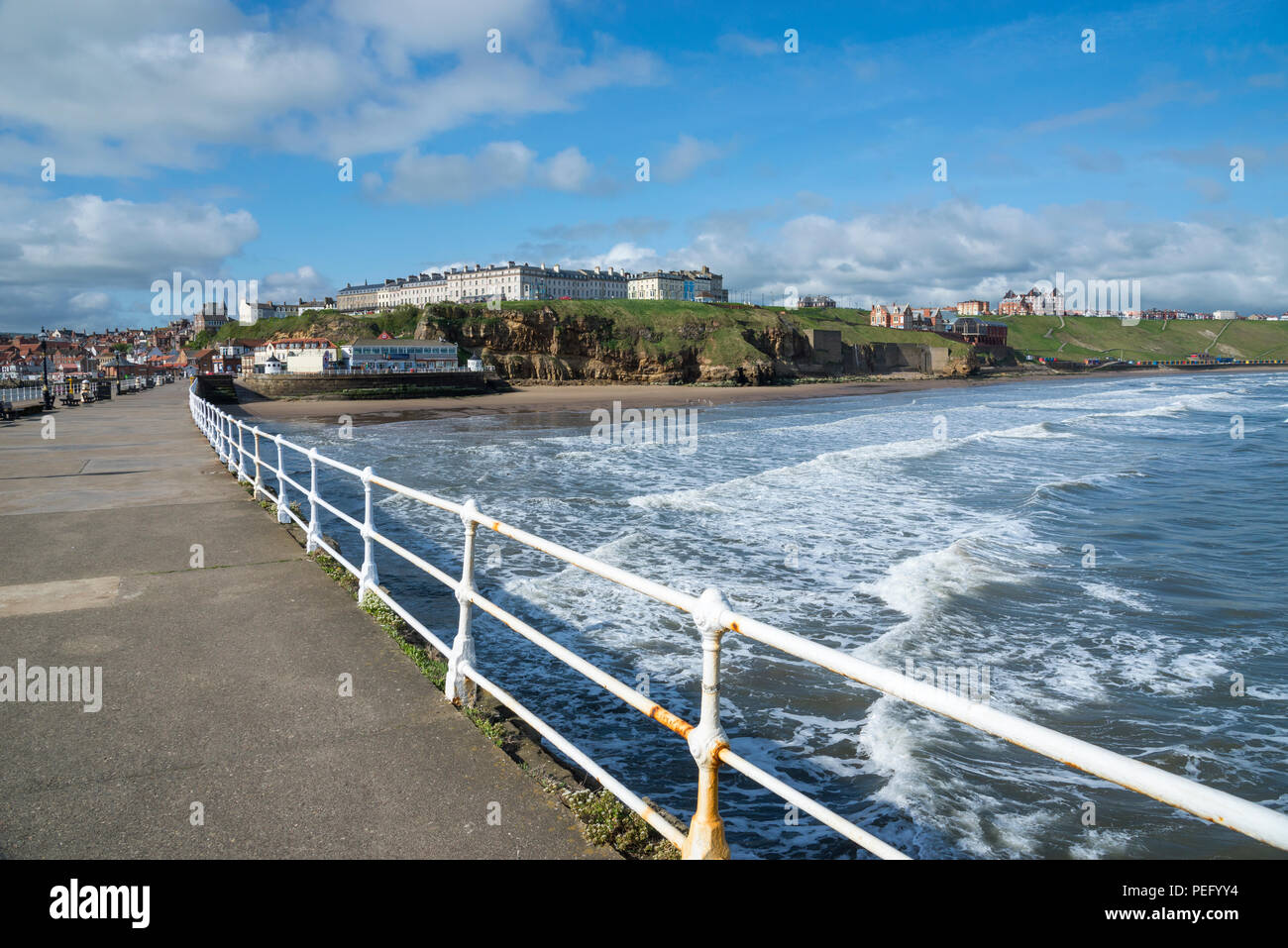 A sunny spring morning on the West Pier at Whitby, North Yorkshire, England. Stock Photo