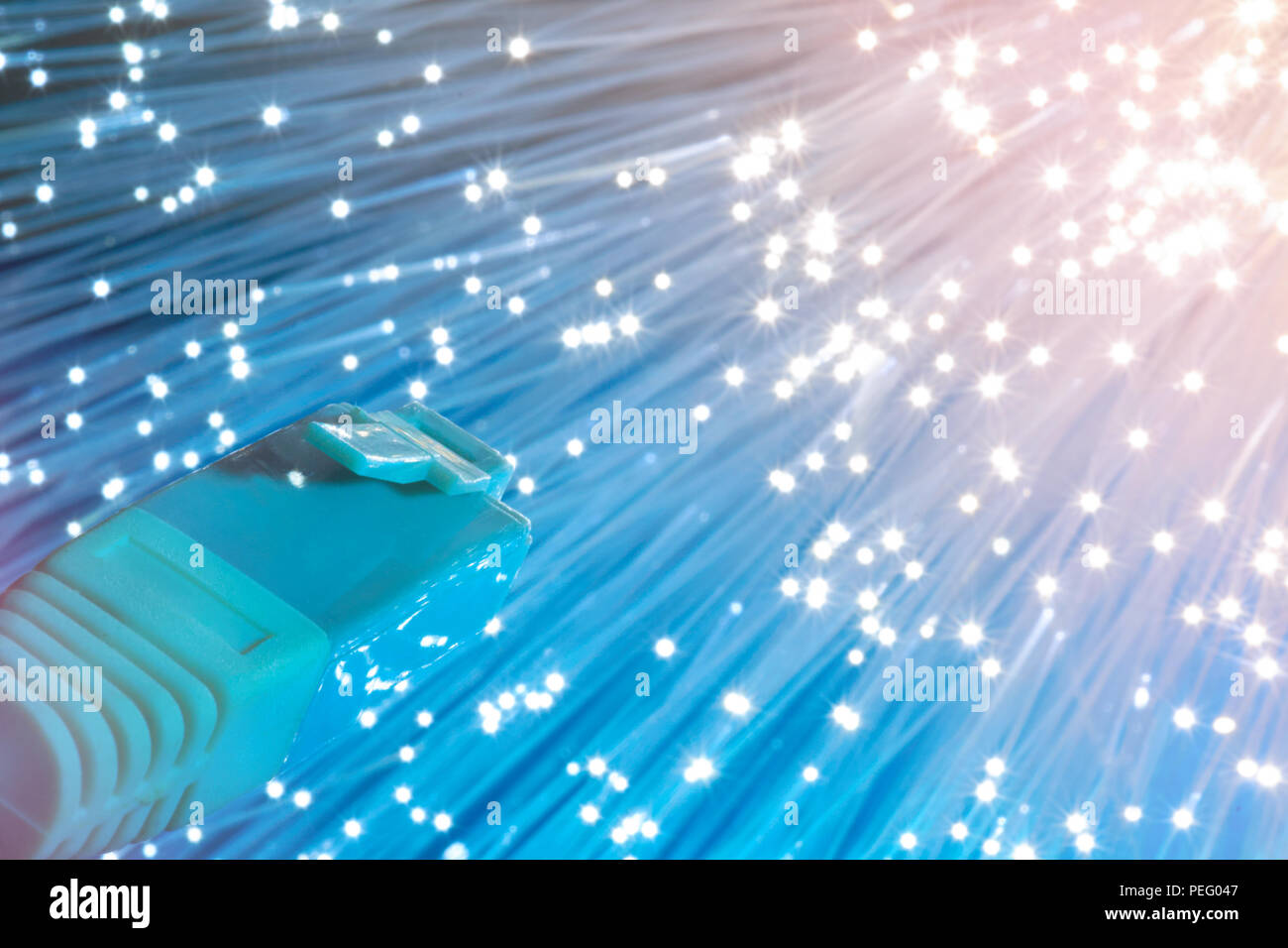 Futuristic technological background, closeup on the end of optical fiber network cable on blue and cream background. Shallow DOF, partial focus on the Stock Photo