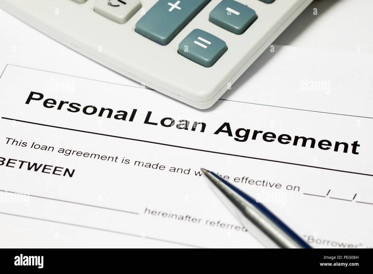 Personal loan agreement, pen and calculator Stock Photo - Alamy