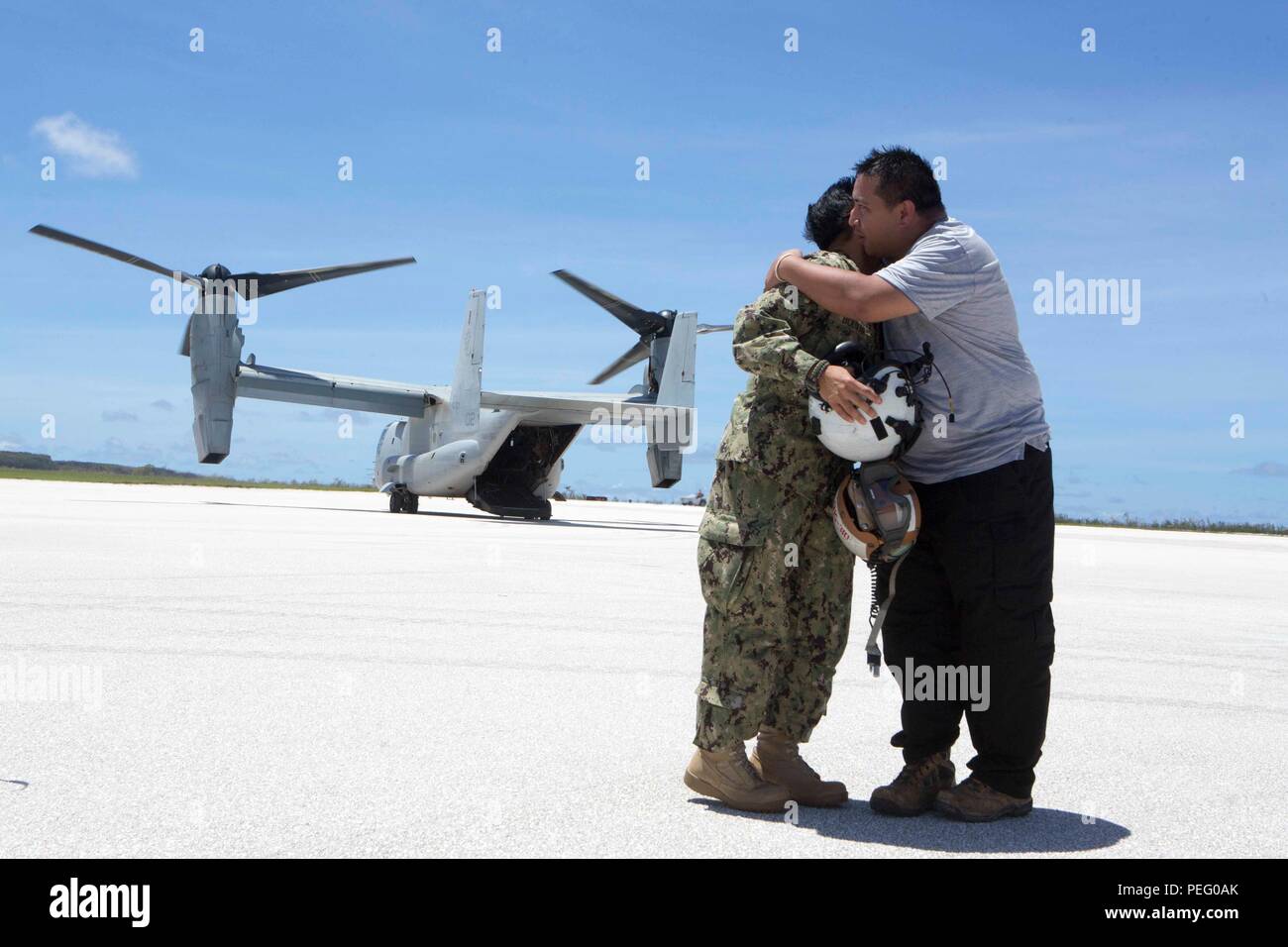Ralph Torres, acting governor of Saipan, embraces U.S. Navy Rear Adm. Bette Bolivar, the commander of U.S. Naval Forces Marianas, after flying over areas of the island damaged by a typhoon Aug. 9, 2015. The 31st Marine Expeditionary Unit and the ships of the Bonhomme Richard Amphibious Ready Group are assisting federal and local agencies with distributing emergency relief supplies to Saipan after it was struck by Typhoon Soudelor Aug. 2-3. (U.S. Marine Corps photo by Lance Cpl. Brian Bekkala/Released) Stock Photo