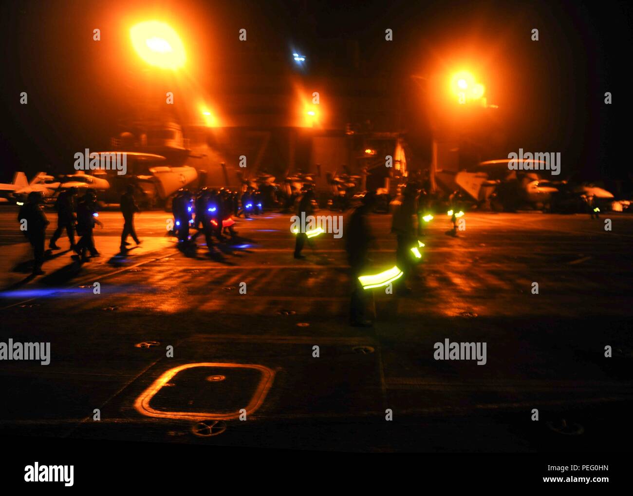 150812-N-ZZ999-060 ARABIAN GULF (Aug. 12, 2015) - Sailors and Marines participate in a foreign object debris  walkdown on the flight deck aboard the aircraft carrier USS Theodore Roosevelt (CVN 71). Theodore Roosevelt is deployed in the U.S. 5th Fleet area of operations supporting Operation Inherent Resolve, strike operations in Iraq and Syria as directed, maritime security operations and theater security cooperation efforts in the region. (U.S. Navy photo by Electrician's Mate 3rd Class Armand Lefebvre/ Released) Stock Photo