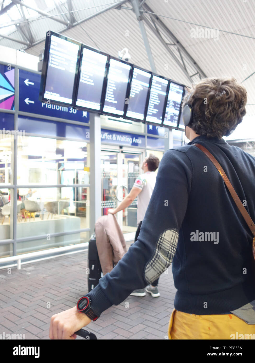 Train delays at Manchester Airport station leaves a young man watching