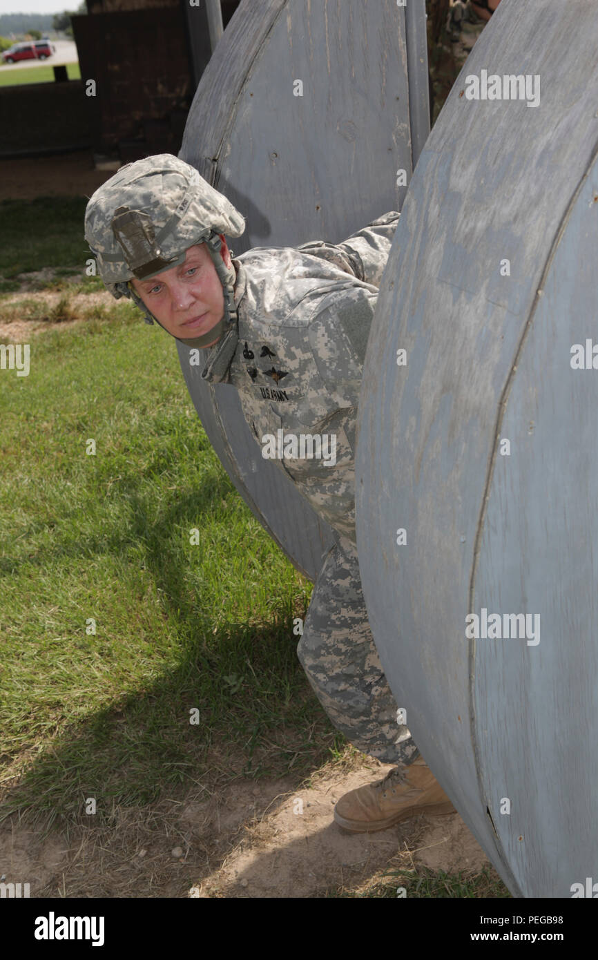 U.S. Army 1st Sergeant conducts a pre-jump inspection on the side of ...