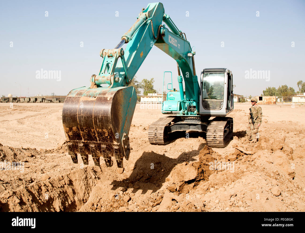 Iraqi army engineers practice digging trenches using a hydraulic excavator at Camp Taji, Iraq, Aug. 11, 2015. Engineer training is critical to the Iraqi army's future success by providing the skills needed to enhance their warfighting capabilities. Combined Joint Task Force - Operation Inherent Resolve's multinational effort is committed to building that capacity within the Iraqi security forces to degrade and ultimately defeat the Islamic State of Iraq and the Levant. (U.S. Army photo by Spc. Paris Maxey/Released) Stock Photo