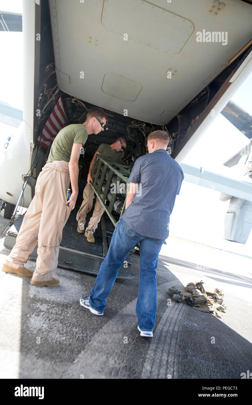 U.S. Marines from Combat Logistics Battalion 31, 31st Marine Expeditionary Unit, load a Light Weight Purification System onto an MV-22B Osprey belonging to Marine Medium Tiltrotor Squadron 265 (Reinforced), 31st MEU, on Anderson Air Force Base, Guam, Aug. 10, 2015. The 31st MEU and the ships of the Bonhomme Richard Amphibious Ready Group are assisting federal and local agencies with distributing emergency relief supplies to Saipan after it was struck by Typhoon Soudelor, Aug. 2-3. (U.S. Marine Corps photo by Lance Cpl. Brian Bekkala/Released) Stock Photo