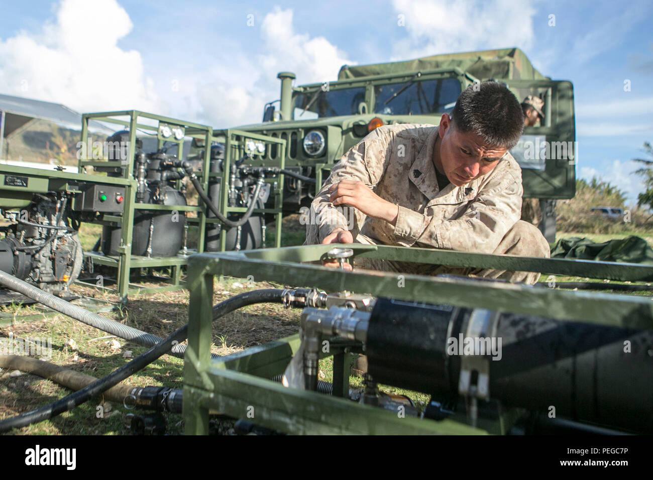 U.S. Marine Sgt. Theron Nez, with Combat Logistics Battalion 31, 31st Marine Expeditionary Unit, assembles a Light Weight Purification System as part of typhoon relief efforts in Saipan, Aug. 10, 2015. The 31st MEU and the ships of the Bonhomme Richard Amphibious Ready Group are assisting federal and local agencies with distributing emergency relief supplies to Saipan after it was struck by Typhoon Soudelor, Aug. 2-3. (U.S. Marine Corps photo by Lance Cpl. Brian Bekkala/Released) Stock Photo