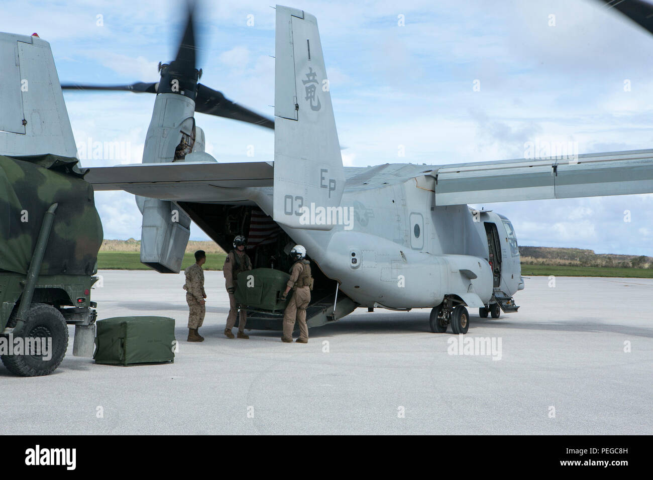 U.S. Marines from Marine Medium Tiltrotor Squadron 265 (Reinforced), 31st Marine Expeditionary Unit, unload a Light Weight Purification System onto a Humvee in Saipan, Aug. 10, 2015. The 31st MEU and the ships of the Bonhomme Richard Amphibious Ready Group are assisting federal and local agencies with distributing emergency relief supplies to Saipan after it was struck by Typhoon Soudelor, Aug. 2-3. (U.S. Marine Corps photo by Lance Cpl. Brian Bekkala/Released) Stock Photo