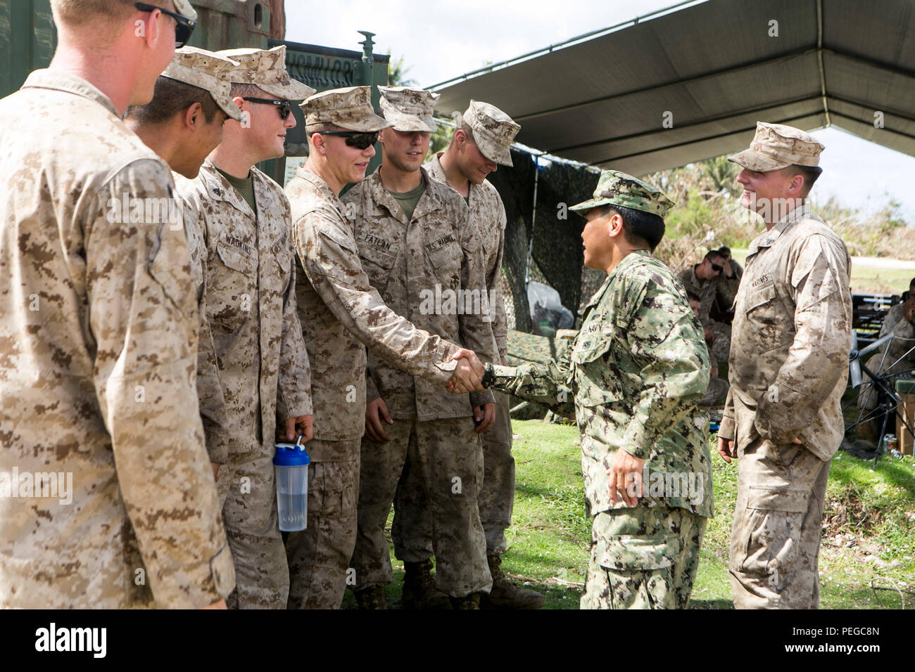 U.S. Navy Rear Adm. Bette Bolivar, the commander of U.S. Naval Forces Marianas, speaks with U.S. Marines from Combat Logistics Battalion 31, 31st Marine Expeditionary Unit, during a tour of a water purification site in Saipan, Aug. 11, 2015.  The Marines of CLB 31, 31st MEU, set up the site as part of typhoon relief efforts. The 31st MEU and the ships of the Bonhomme Richard Amphibious Ready Group are assisting the Federal Emergency Management Agency with distributing emergency relief supplies to Saipan after the island was struck by Typhoon Soudelor, Aug. 2-3. (U.S. Marine Corps photo by Lanc Stock Photo