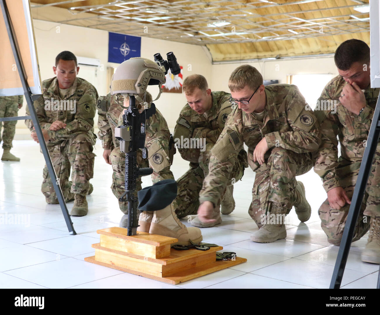 U.S. Army Soldiers and teammates of 1st Sgt. Peter "Drew" McKenna, Jr. pay  tribute to him during a memorial at Camp Integrity. The event honored  McKenna, 35, and his selfless service while