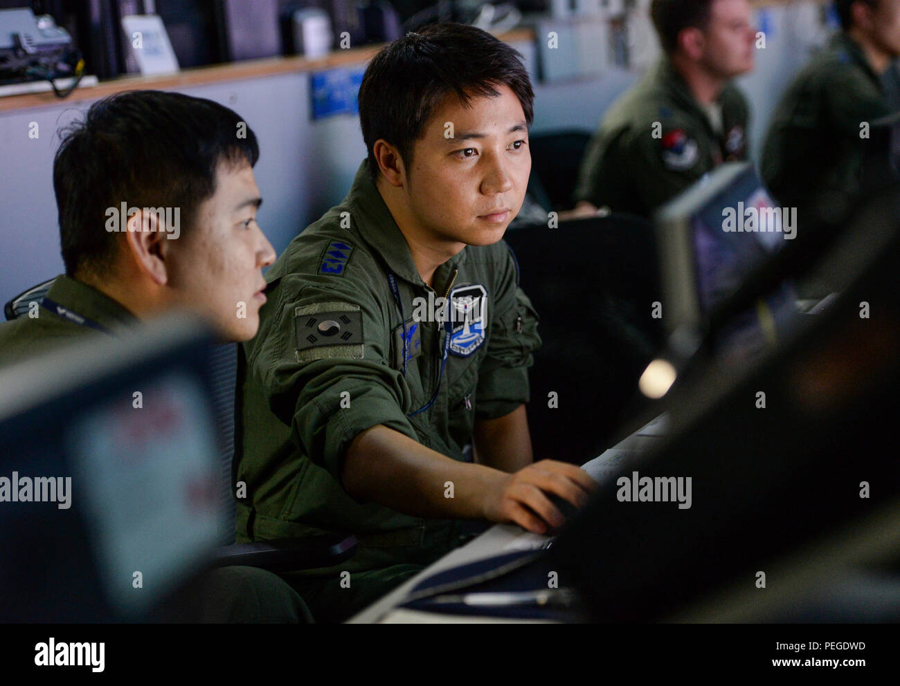 Republic of Korea Air Force Capt. Won Jung Seung, 6th Rescue Group pilot, monitors ROK air space at the Hardened Theater Air Control Center, Osan Air Base, ROK, during the first day of Ulchi Freedom Guardian, Aug. 17, 2015. Part of Won’s responsibility is to receive and relay vital information to commanders in order to support air rescue operations. UFG is an annual exercise that brings together U.S., ROK and other allied forces in an effort to ensure readiness to defend the ROK and help maintain stability on the Korean Peninsula. (U.S. Air Force photo/Airman 1st Class John Linzmeier) Stock Photo