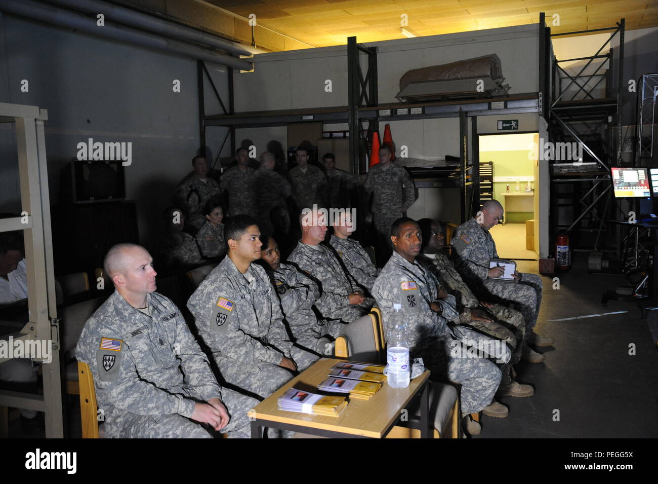 U.S. Soldiers stationed in Smith Barracks listen to the speakers at the