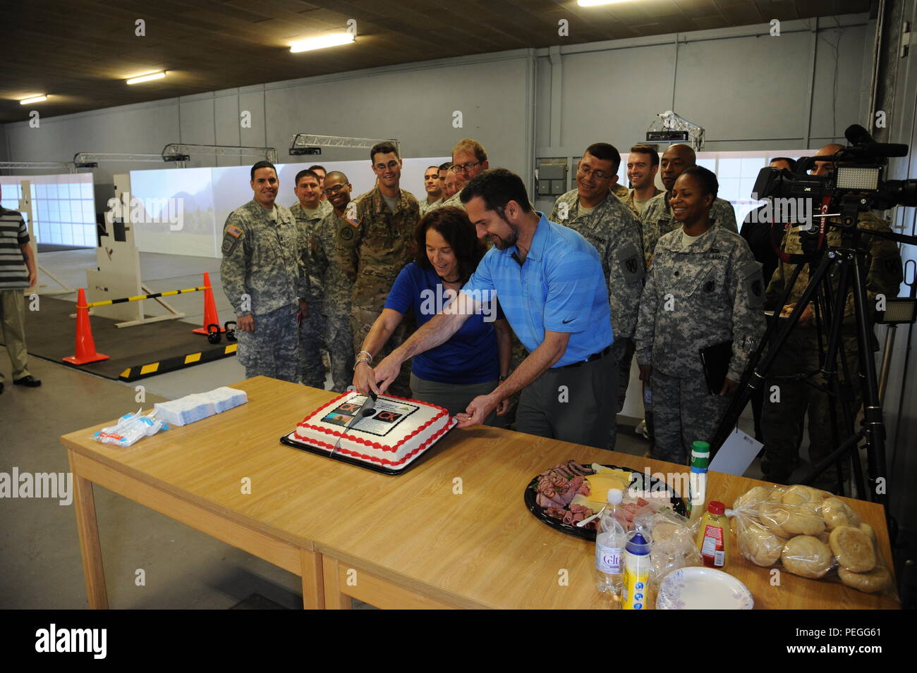Alison B. Rubin and another employee of Conflict cut the cake