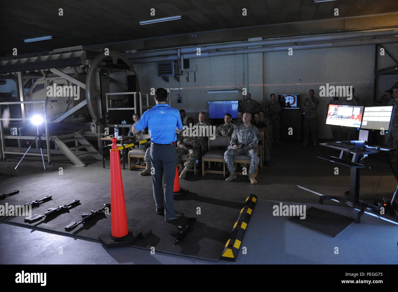 An employee of Conflict explains to the invited guests the