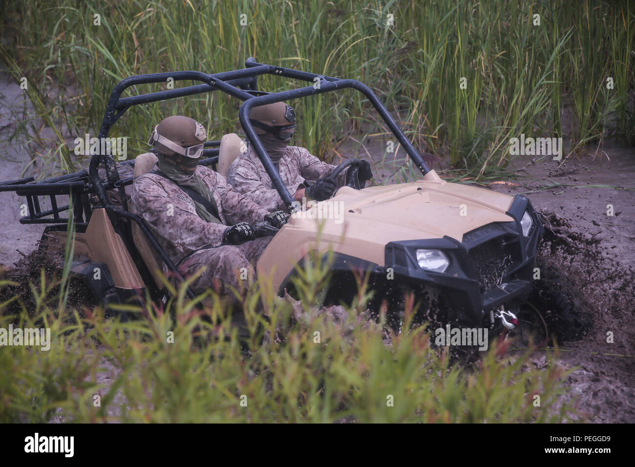 Marines with Force Reconnaissance Platoon, 22nd Marine Expeditionary Unit, drive through a fording pit during an all - terrain vehicle course aboard Camp Lejeune, N.C., Aug. 18, 2015. Marines drove the Polaris Rzr tactical vehicles through a water pit to gain experience with vehicle handling in swampy terrain. (U.S. Marine Corps photo by Lance Cpl. Aaron Fiala/Released) Stock Photo