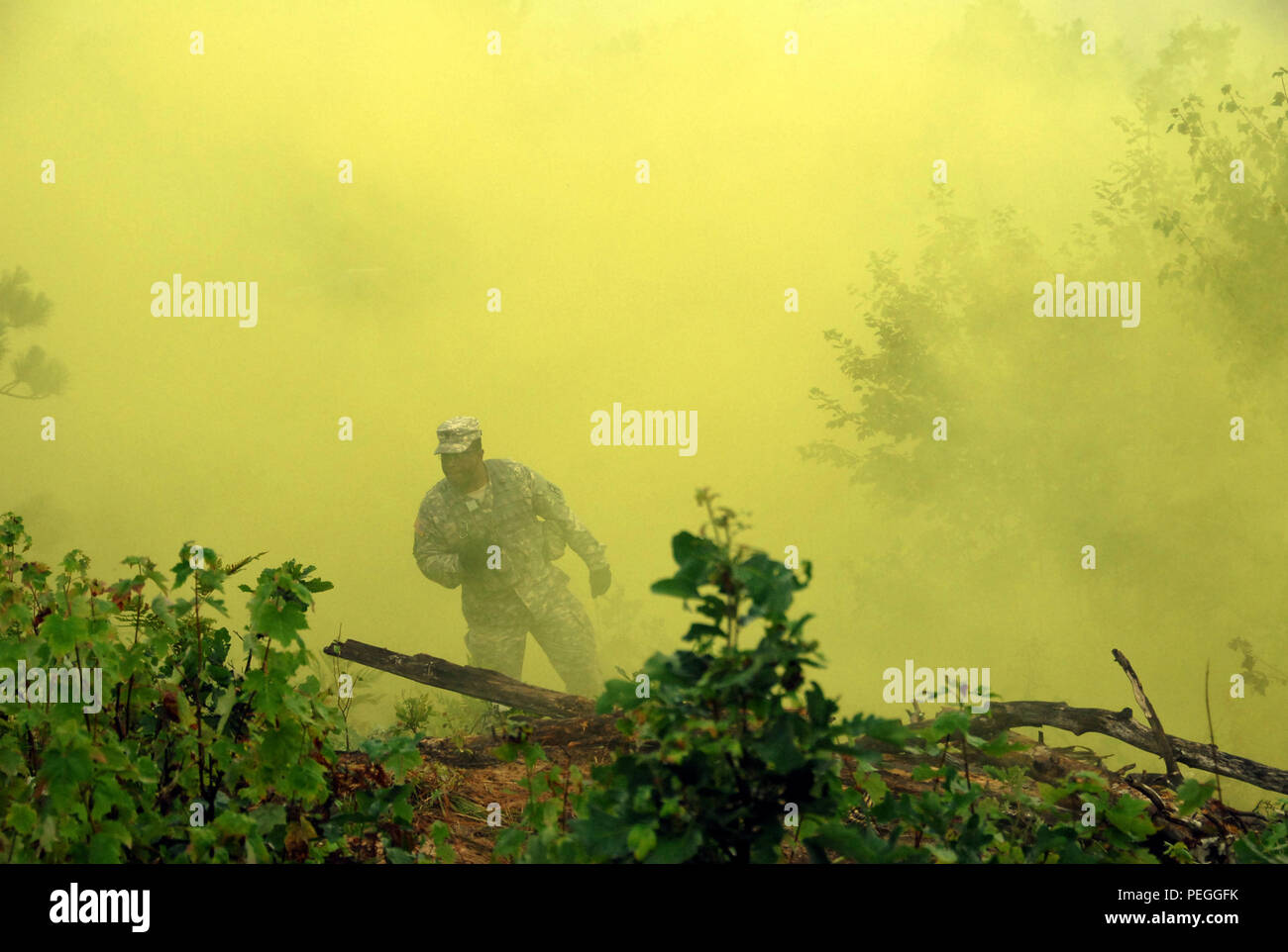 A Michigan National Guard infantry Soldier from the Detroit-based Company A, 1st Battalion, 125th Infantry Regiment defends his position during training at Camp Grayling, Joint Maneuver Training Center, Grayling, Mich., Aug. 18, 2015. The Soldiers are participating in the exportable combat training capability program designed to certify platoon proficiency in coordination with First Army. (U.S. Air National Guard photo by 2nd Lt. Cammy Alberts/Released) Stock Photo