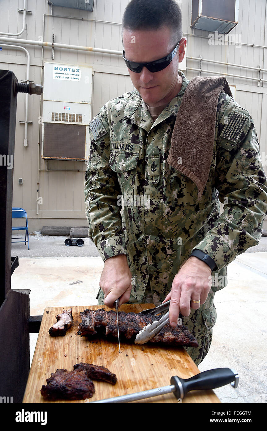 Prepares ribs during a barbecue cook off at naval base coronado hi-res ...