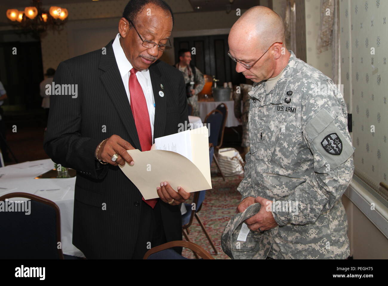 Selma Mayor George Patrick Evans (left) and Warrant Officer Steven R. Yacks (right), a health services maintenance technician with the Army Reserve Medical Command, discuss details of the West Black Belt Innovative Readiness Training Program in Selma, Ala., Aug. 11. The IRT operation provides medical, dental, and eye screenings at no charge to the Black Belt region of south central Alabamian residents of Selma, and nearby townships of Demopolis and Camden. The medical support and services provided to the communities are incidental to the training of the military units involved. (U.S. Army phot Stock Photo