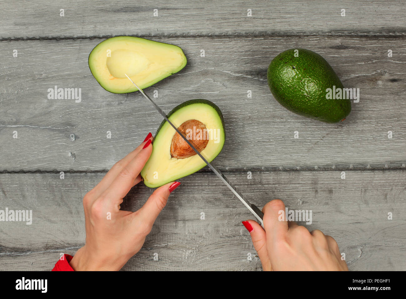 Tabletop View Woman Hand Holding Chef Knife Removing Seed From Avocado Cut In Half Stock Photo Alamy Tabletop View Woman Hand Holding Chef Knife Removing Seed From Avocado Cut In Half Stock Photo Alamy