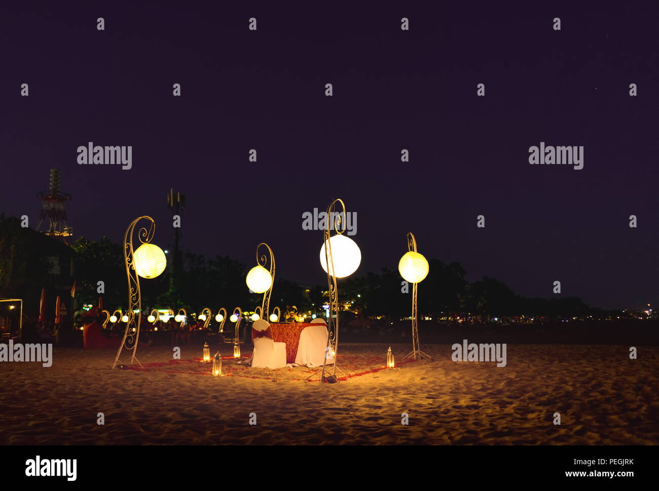 Outdoor Romantic Dinner Table For Two At Stary Night Sky At The Beach Like Restaurant Concept of 1001 Arabian Night Stock Photo