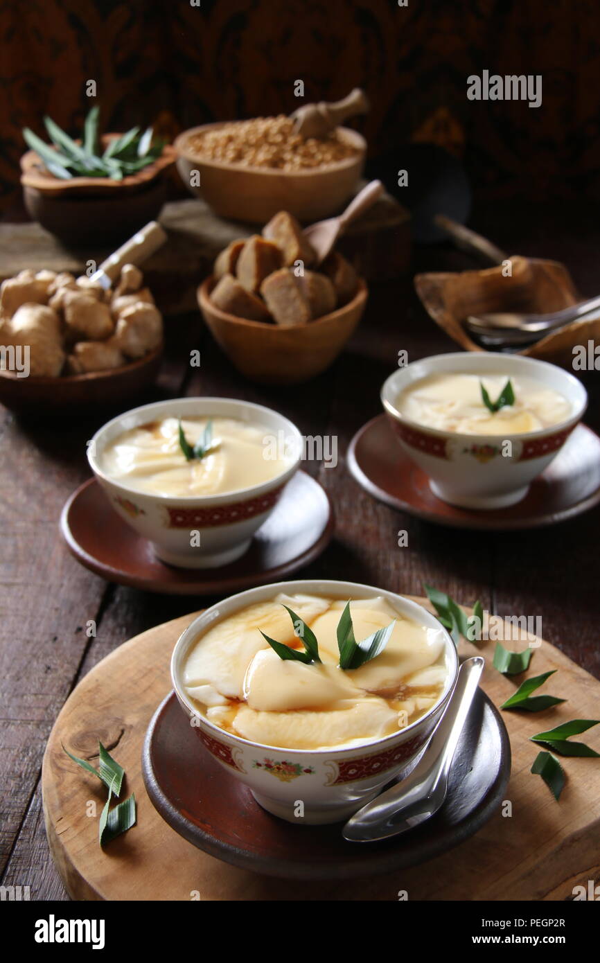 Wedang Tahu. Peranakan-Javanese warm dessert of tofu pudding in ginger and palm sugar syrup. Stock Photo