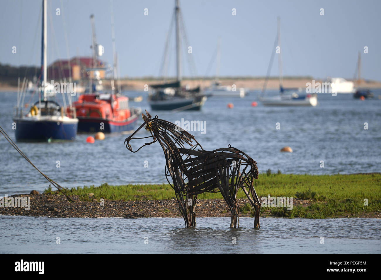 The "Lifeboat Horse" sculpture by Rachael Long stands on the mud flats during low tide at Wells