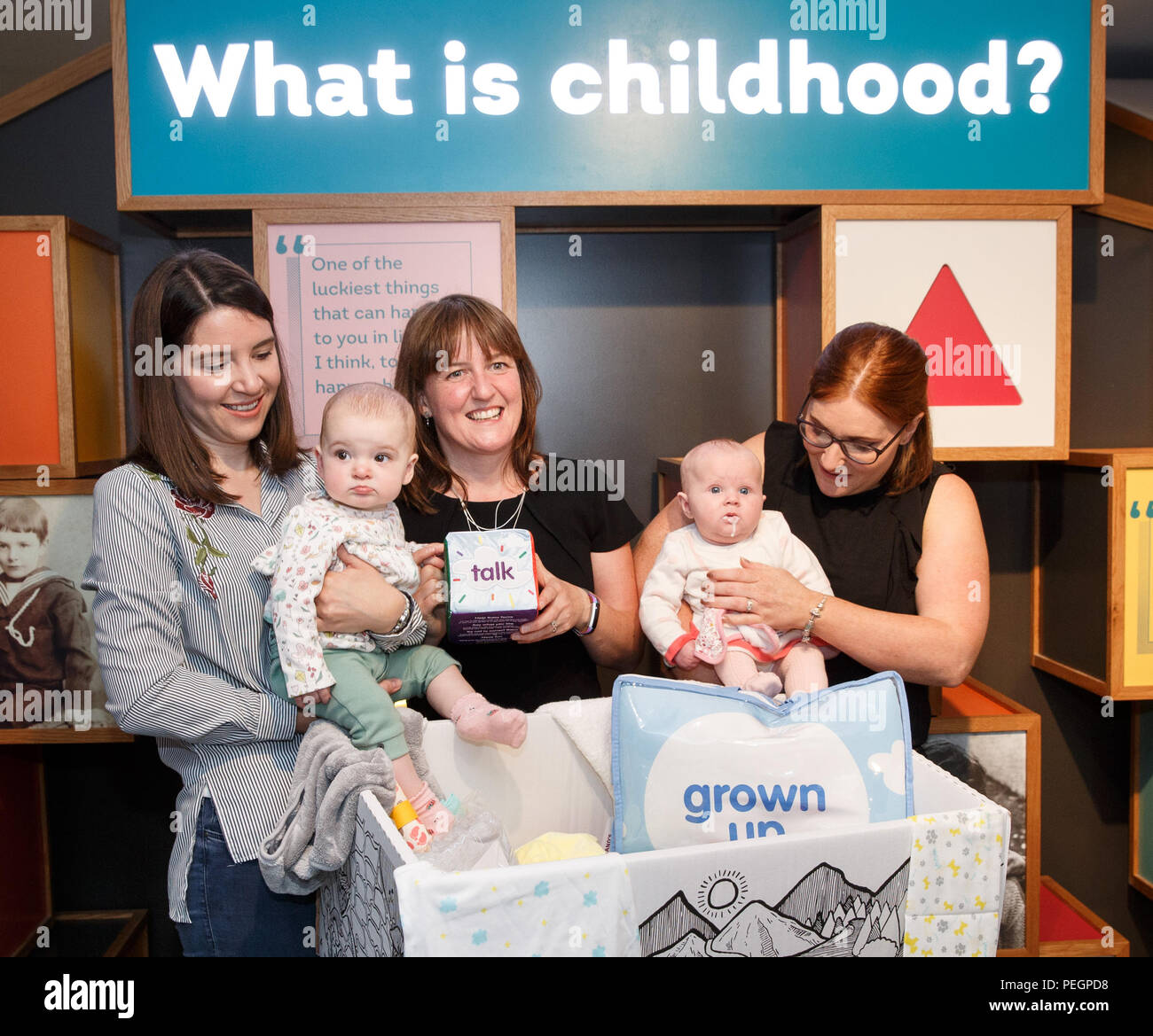 Maree Todd (third left), Minister for Children and Young People, with (left to right) Sarah Morrison and daughter Chrissie, Gillian Steele with daughter Erin, marks the first anniversary of the Baby Box initiative at the Museum of Childhood, as one of the boxes is to be preserved in history as an exhibit at the Edinburgh attraction. Stock Photo