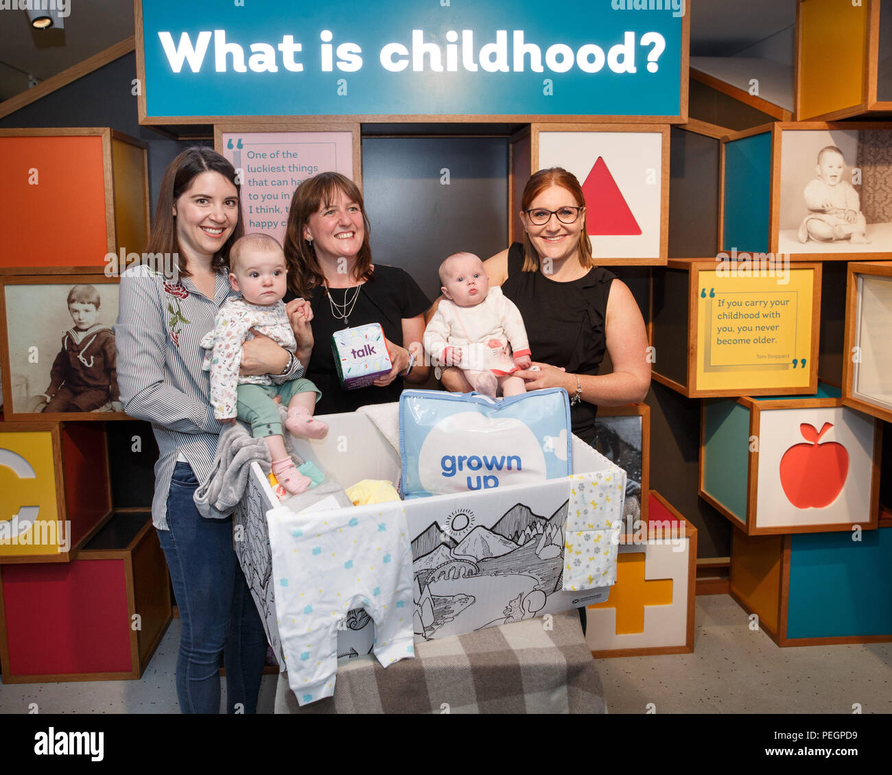 Maree Todd (third left), Minister for Children and Young People, with (left to right) Sarah Morrison and daughter Chrissie, Gillian Steele with daughter Erin, marks the first anniversary of the Baby Box initiative at the Museum of Childhood, as one of the boxes is to be preserved in history as an exhibit at the Edinburgh attraction. Stock Photo