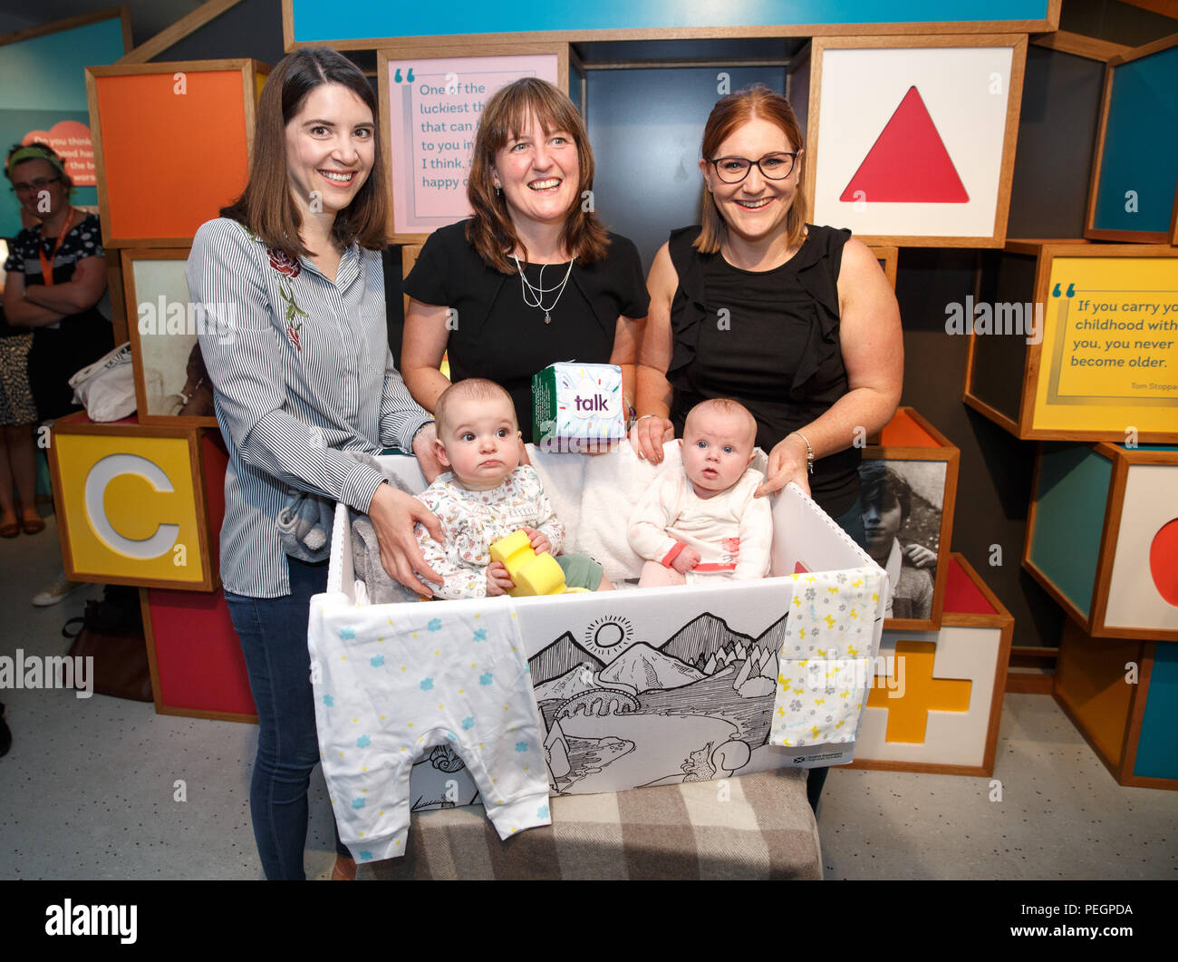 Maree Todd (centre back row), Minister for Children and Young People, with Sarah Morrison (left) and daughter Chrissie, Gillian Steele with daughter Erin, marks the first anniversary of the Baby Box initiative at the Museum of Childhood, as one of the boxes is to be preserved in history as an exhibit at the Edinburgh attraction. Stock Photo