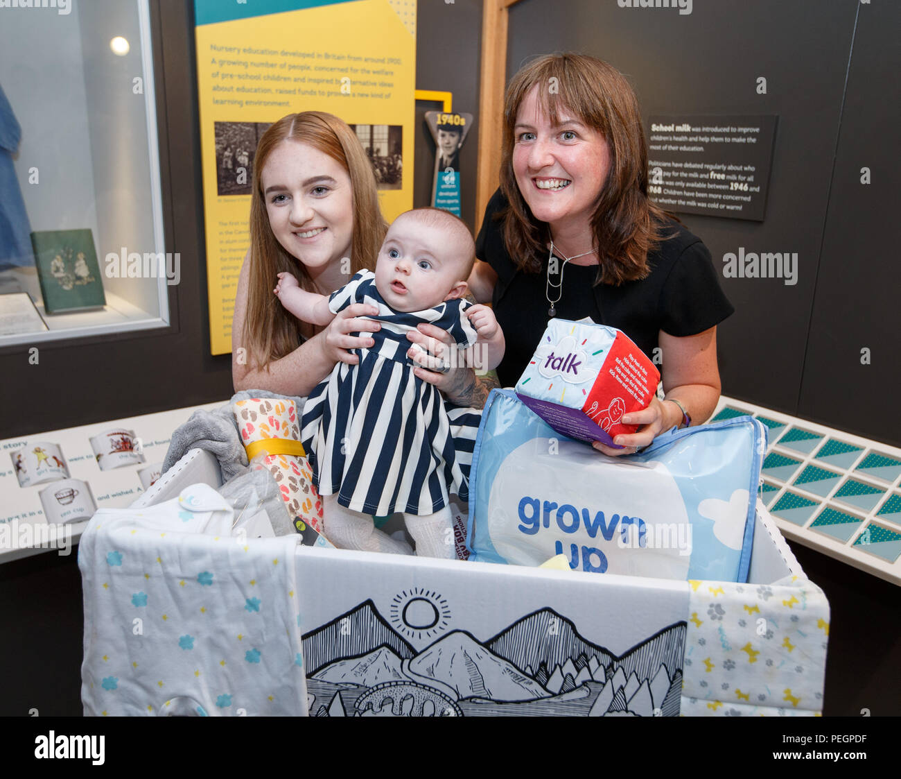 Maree Todd (right), Minister for Children and Young People, with Jennifer Scott and her daughter Hailie who received the box, marks the first anniversary of the Baby Box initiative at the Museum of Childhood as one of the boxes is to be preserved in history as an exhibit at the Edinburgh attraction. Stock Photo