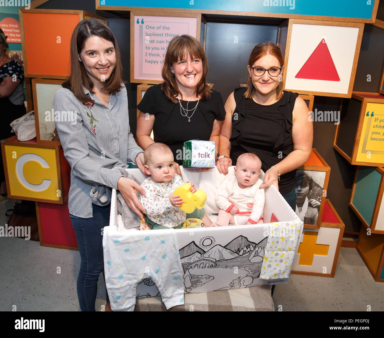 Maree Todd (centre back row), Minister for Children and Young People, with Sarah Morrison (left) and daughter Chrissie, Gillian Steele with daughter Erin, marks the first anniversary of the Baby Box initiative at the Museum of Childhood, as one of the boxes is to be preserved in history as an exhibit at the Edinburgh attraction. Stock Photo