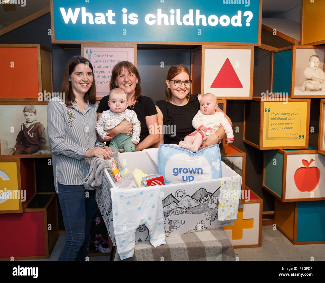 Maree Todd (third left), Minister for Children and Young People, with (left to right) Sarah Morrison and daughter Chrissie, Gillian Steele with daughter Erin, marks the first anniversary of the Baby Box initiative at the Museum of Childhood, as one of the boxes is to be preserved in history as an exhibit at the Edinburgh attraction. Stock Photo