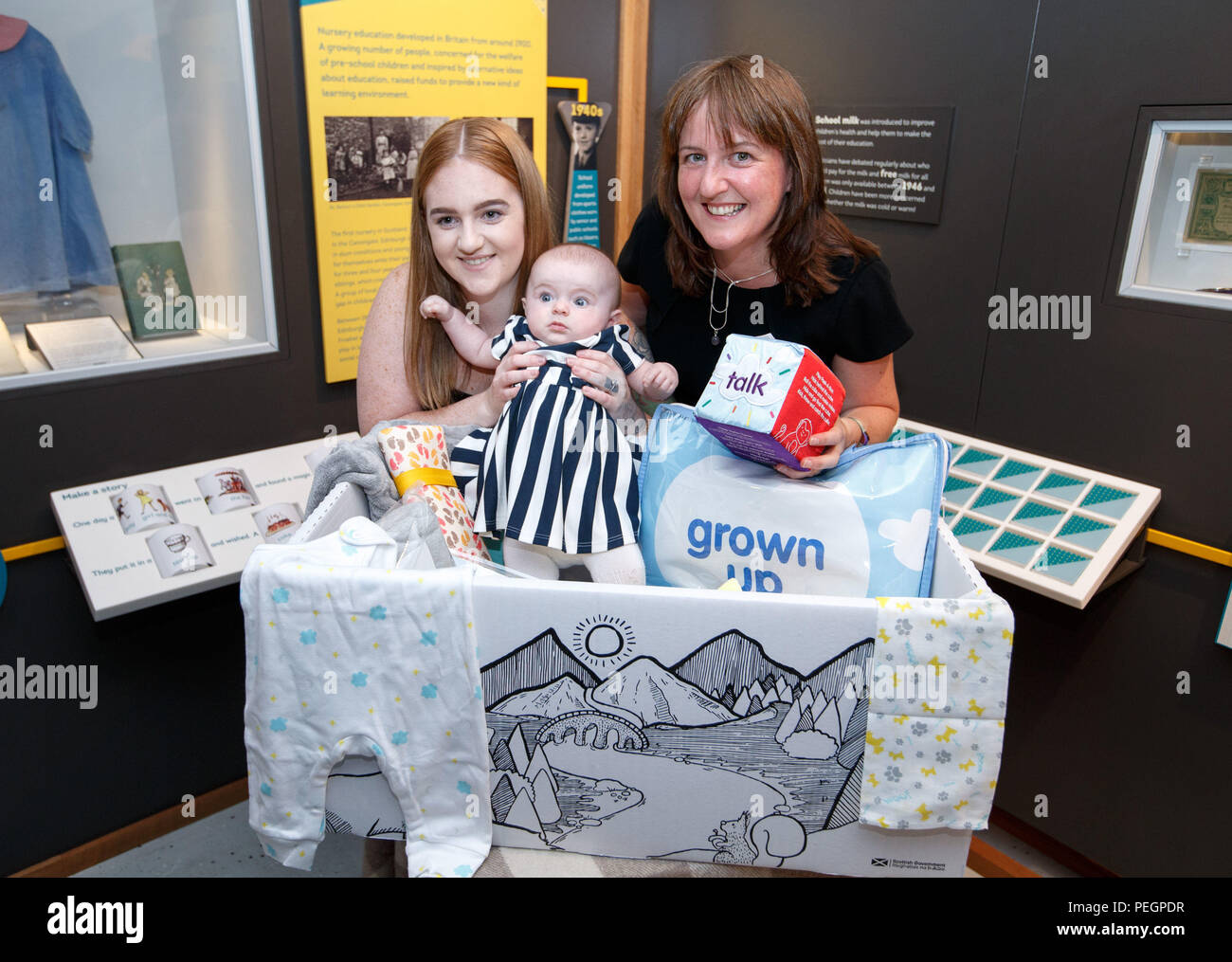 Maree Todd (right), Minister for Children and Young People, with Jennifer Scott and her daughter Hailie who received the box, marks the first anniversary of the Baby Box initiative at the Museum of Childhood as one of the boxes is to be preserved in history as an exhibit at the Edinburgh attraction. Stock Photo