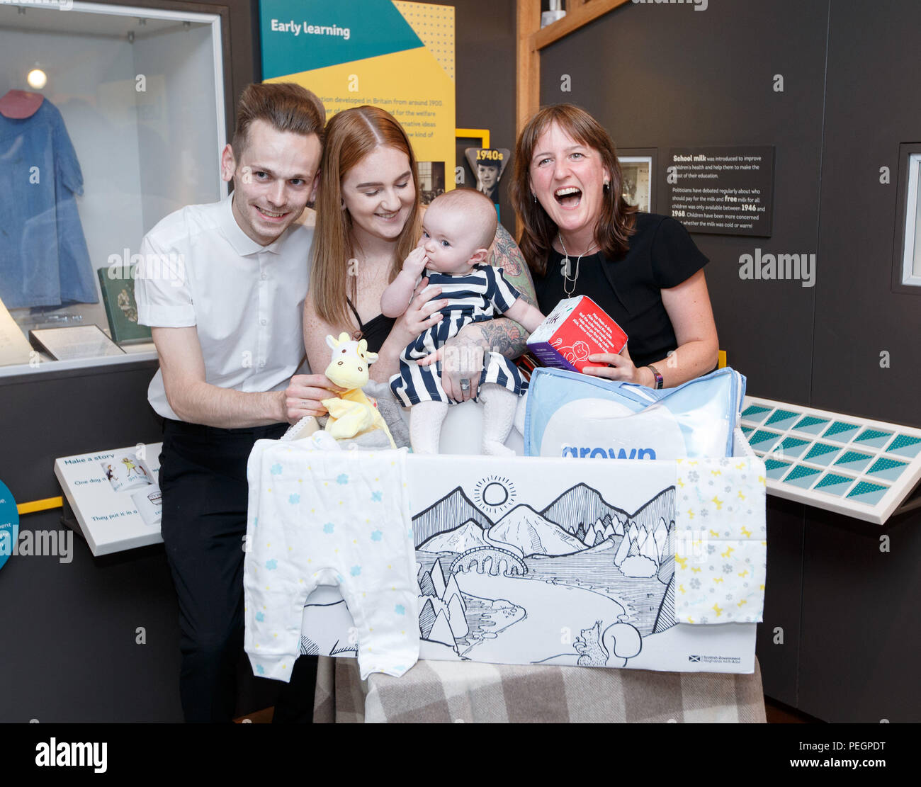 Maree Todd (right), Minister for Children and Young People, with Jennifer Scott and Alasdair Lawrie and their daughter Hailie who received the box, marks the first anniversary of the Baby Box initiative at the Museum of Childhood as one of the boxes is to be preserved in history as an exhibit at the Edinburgh attraction. Stock Photo