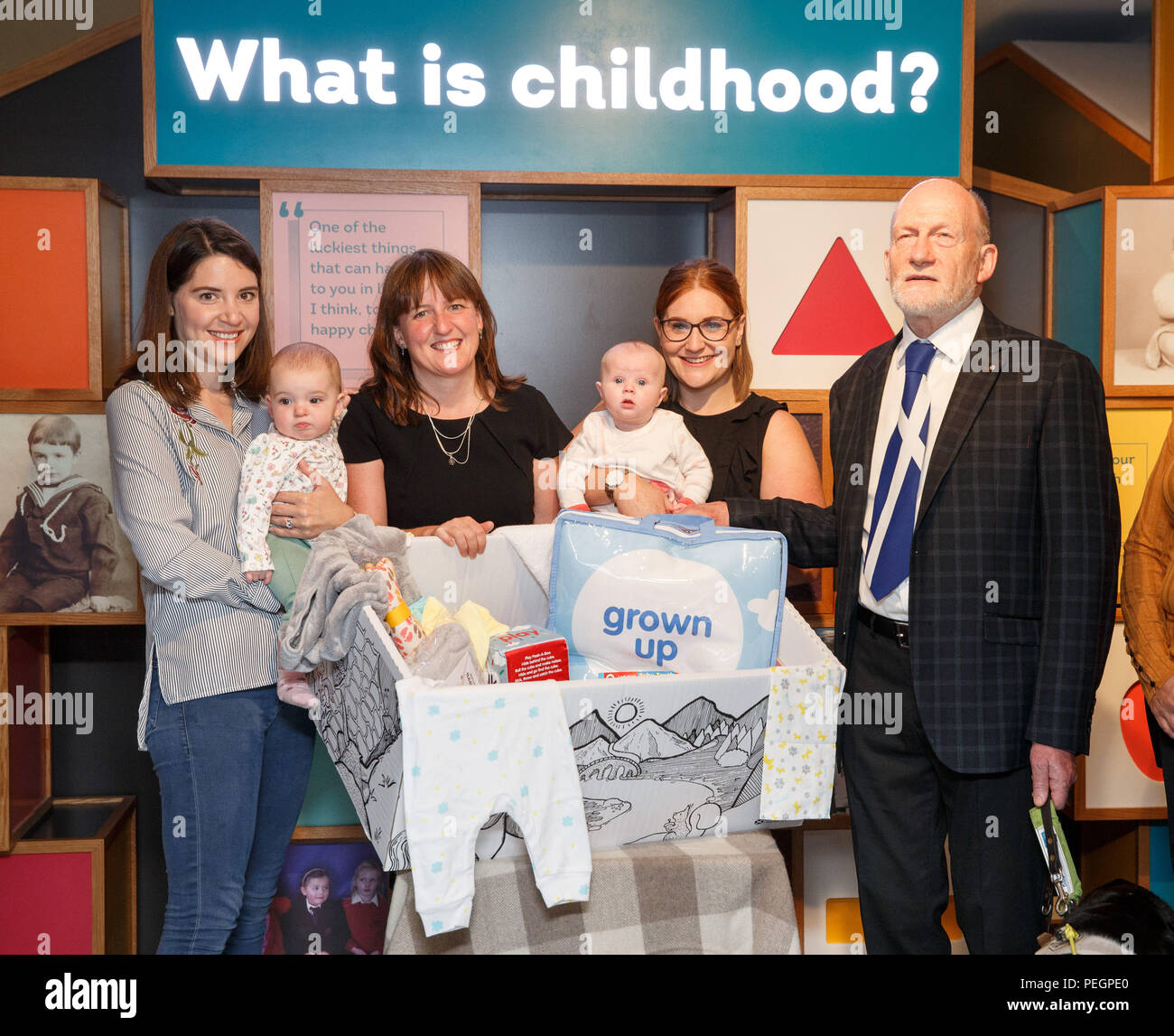 Maree Todd (second left), Minister for Children and Young People, with (left to right) Sarah Morrison and daughter Chrissie, Gillian Steele with daughter Erin and Councillor Derek Howie, marks the first anniversary of the Baby Box initiative at the Museum of Childhood, as one of the boxes is to be preserved in history as an exhibit at the Edinburgh attraction. Stock Photo