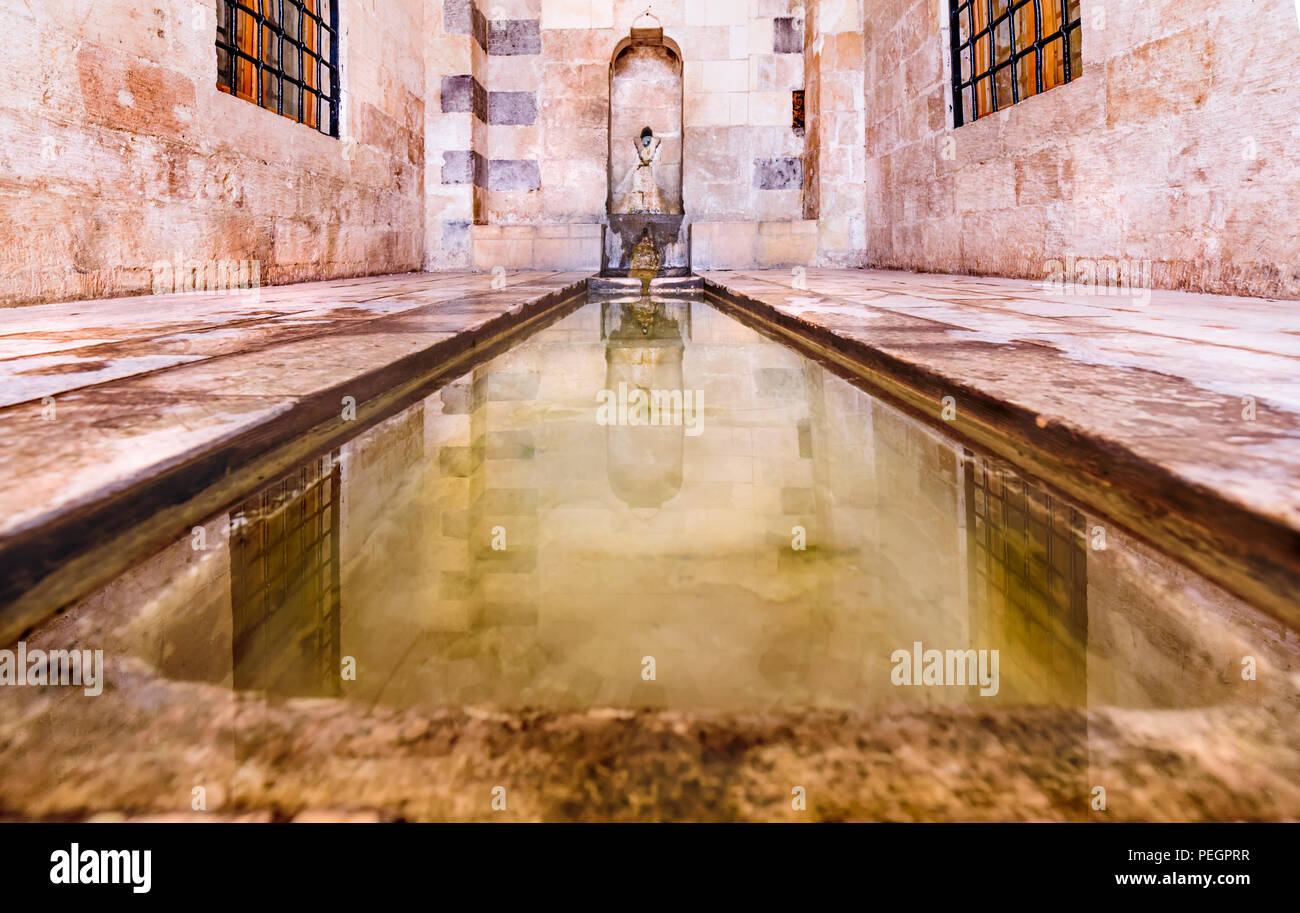 View of fountain for ablution in courtyard of Zinciriye Madrassa in Mardin,Turkey. Stock Photo