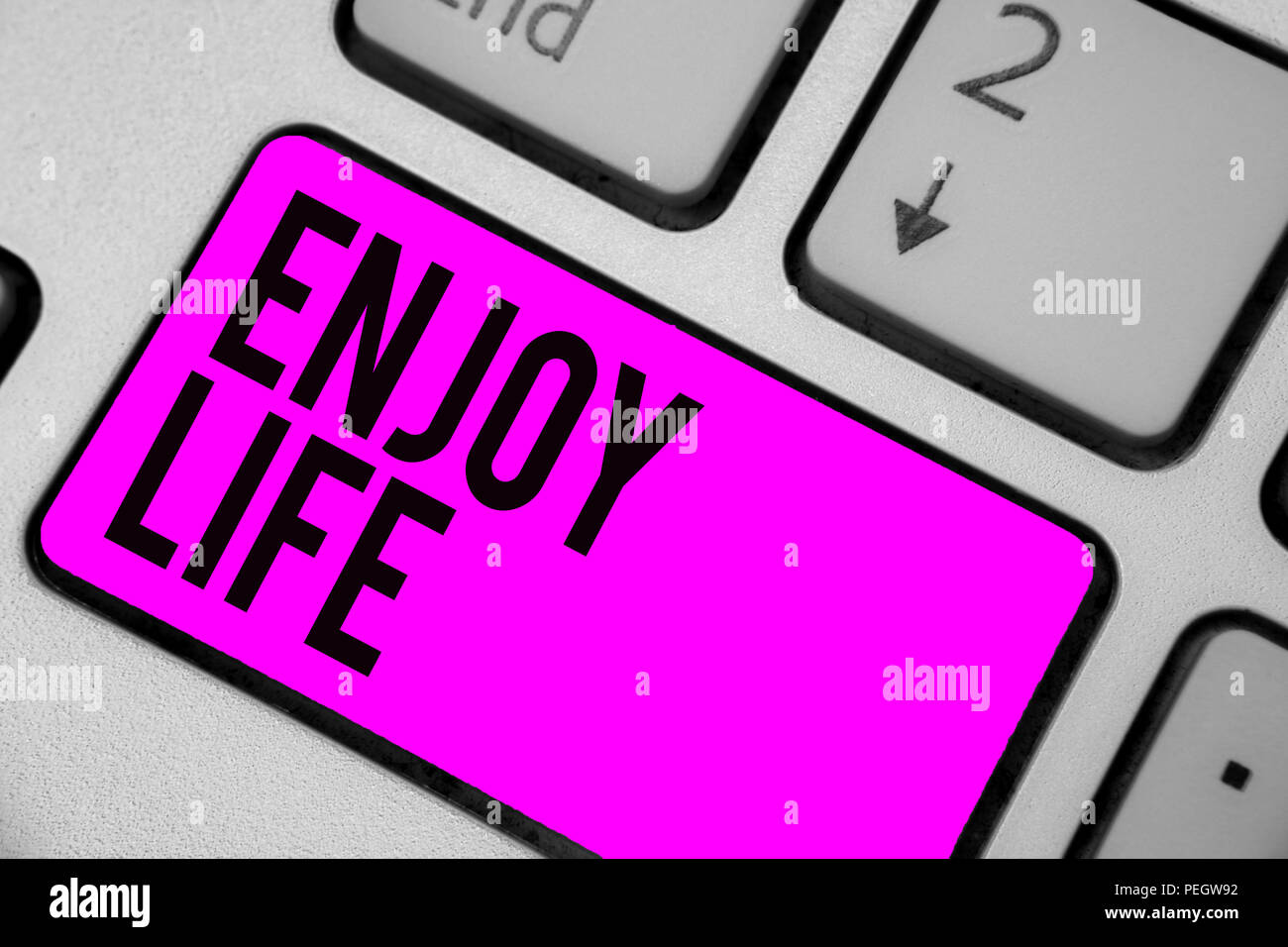 Text sign showing Enjoy Life. Conceptual photo Any thing, place,food or person, that makes you relax and happy Keyboard purple key Intention create co Stock Photo