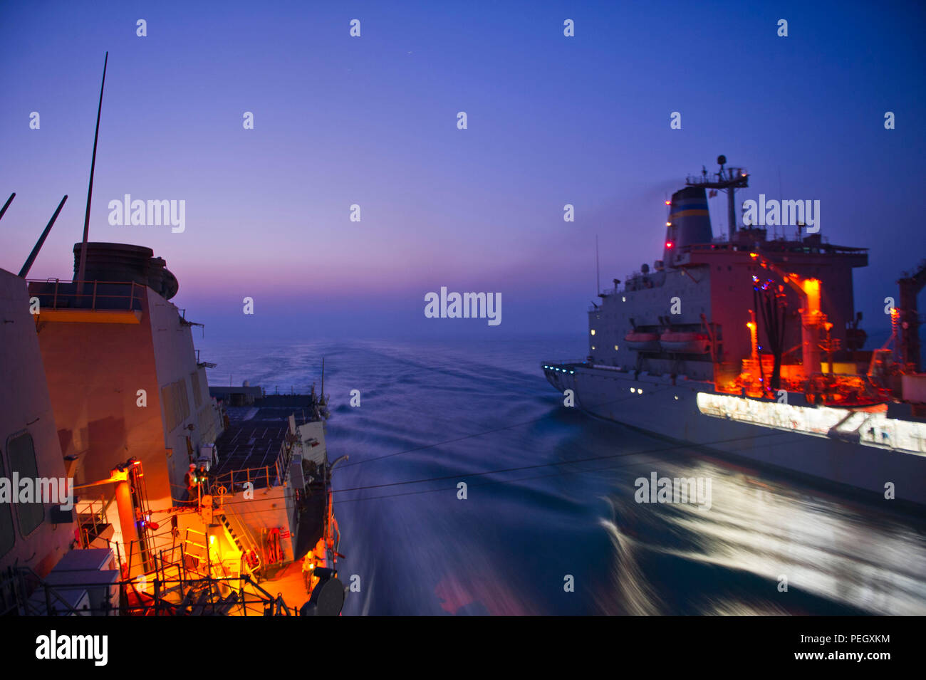 150818-N-KU391-145 ARABIAN GULF, at sea (August 18, 2015) – Sailors aboard the Arleigh Burke-class guided missile destroyer USS Winston S. Churchill (DDG 81) conduct an underway replenishment with the Military Sealift Command’s Fleet Replenishment Oiler USNS Patuxent (T-AO-201). Churchill is deployed in the U.S. 5th Fleet area of operations supporting Operation Inherent Resolve, strike operations and theater security cooperation efforts in the region. (U.S. Navy photo by Mass Communication Specialist 3rd Class Josh Petrosino/Released) Stock Photo