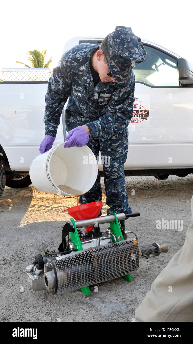 150819-N-HL010-001 KEY WEST, Fla. (Aug. 19, 2015) Hospital Corpsman 1st Class Evan Sumners mixes a larvicide application at a Stock Island boatyard. Navy Entomology Center of Excellence in Jacksonville, Fla., chose Key West as its testing site for thermal fogging with mosquito larvicide because its tropical climate is representative of areas around the world where there is a potential for military presence. (U.S. Navy photo by Jolene Scholl/ Released) Stock Photo