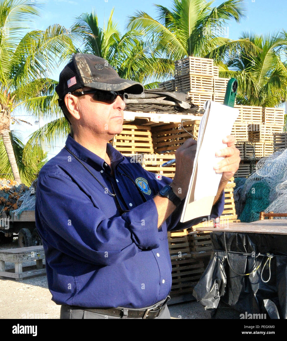 150819-N-HL010-003 KEY WEST, Fla. (Aug. 19, 2015) Medical Entomologist James Cilek records wind speed during a larvicide application at a Stock Island boatyard. Navy Entomology Center of Excellence in Jacksonville, Florida, chose Key West as its testing site for thermal fogging with mosquito larvicide its tropical climate is representative of areas around the world where there is a potential for military presence. (U.S. Navy photo by Jolene Scholl/ Released) Stock Photo