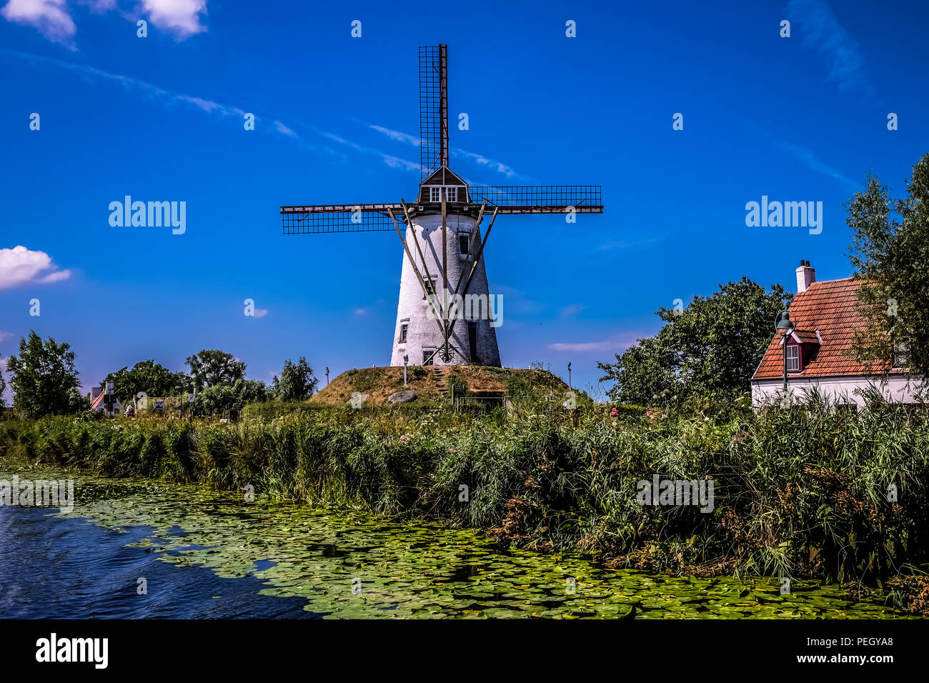 Landscape view of the The windmill of Hoeke, in the city of Damme near Bruges in northern Belgium, with cloudy sky in the background Stock Photo