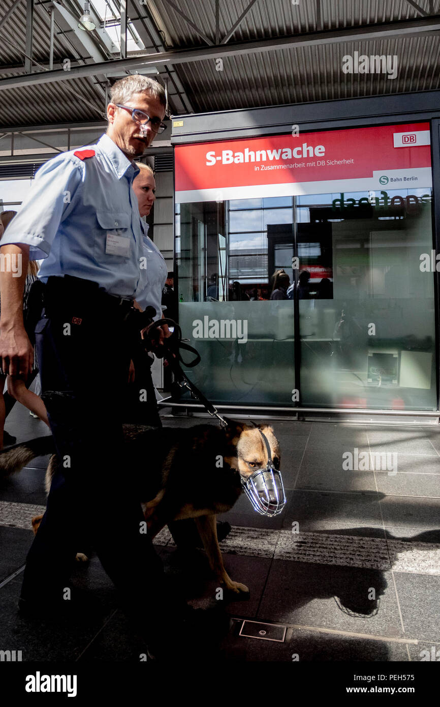 15 August 2018, Berlin, Germany: Sven Montwill of DB Sicherheit walks in front of the new S-Bahn guard patrol with service dog 'Teufel' at the inauguration of the second of a total of five new S-Bahn guards at Ostkreuz station. Security forces are there day and night, accompanied and supported by protection dogs. Photo: Christoph Soeder/dpa Stock Photo